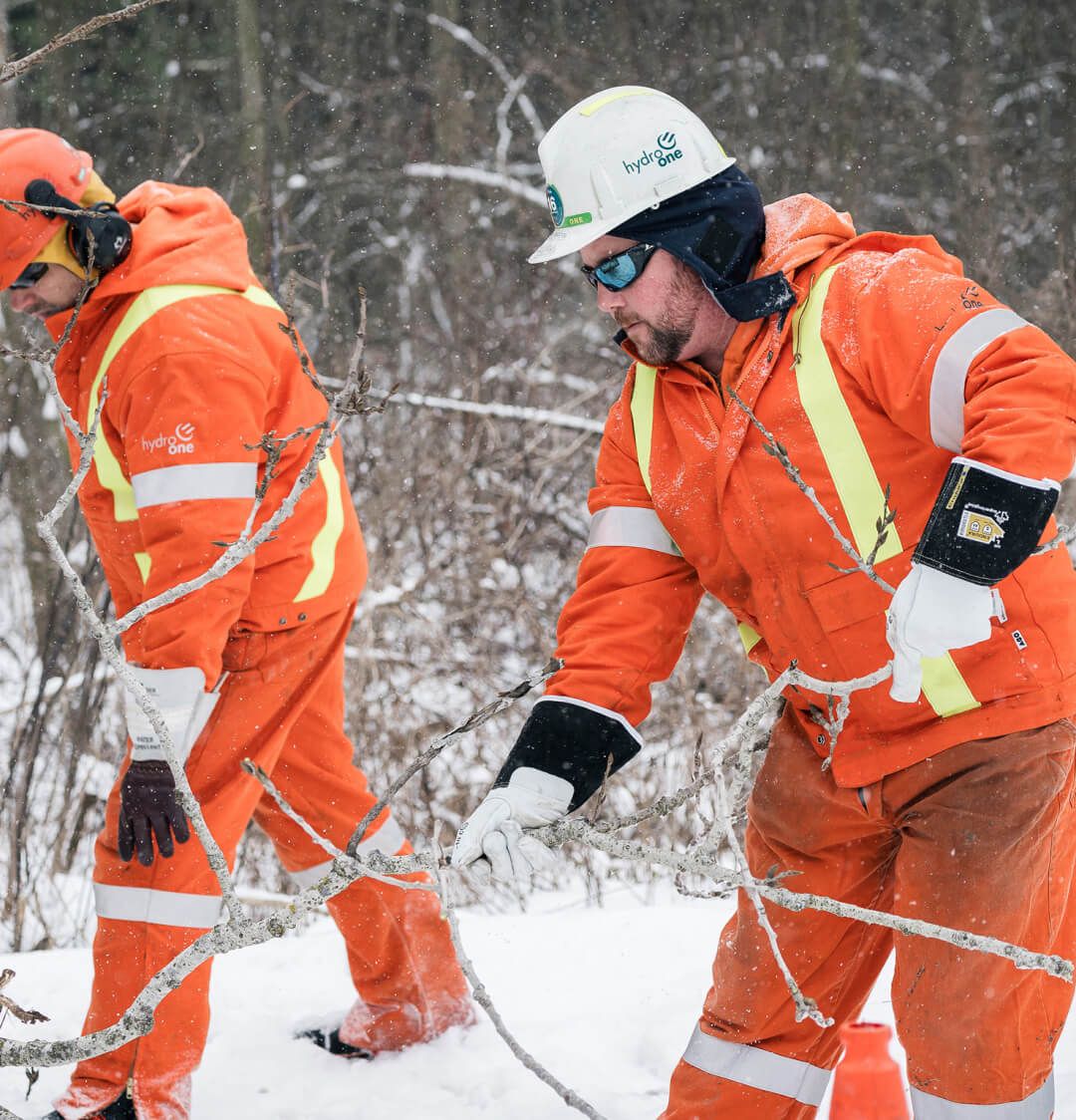 Hydro one employees cleaning up during the winter