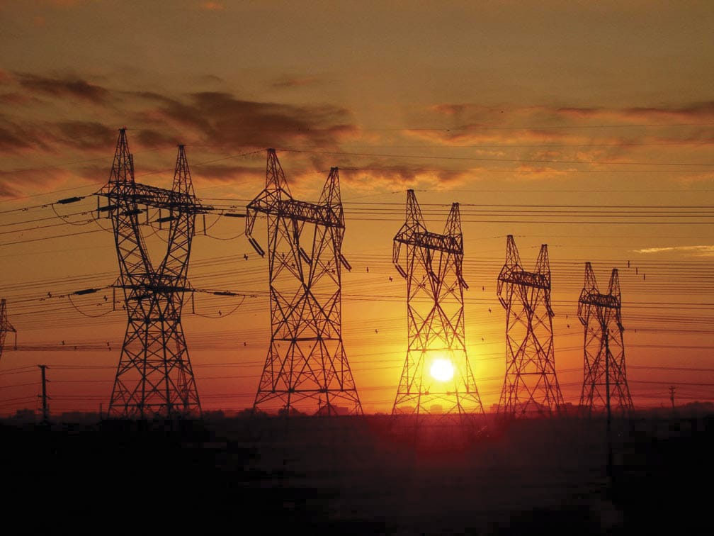 image of transmission towers at sunset